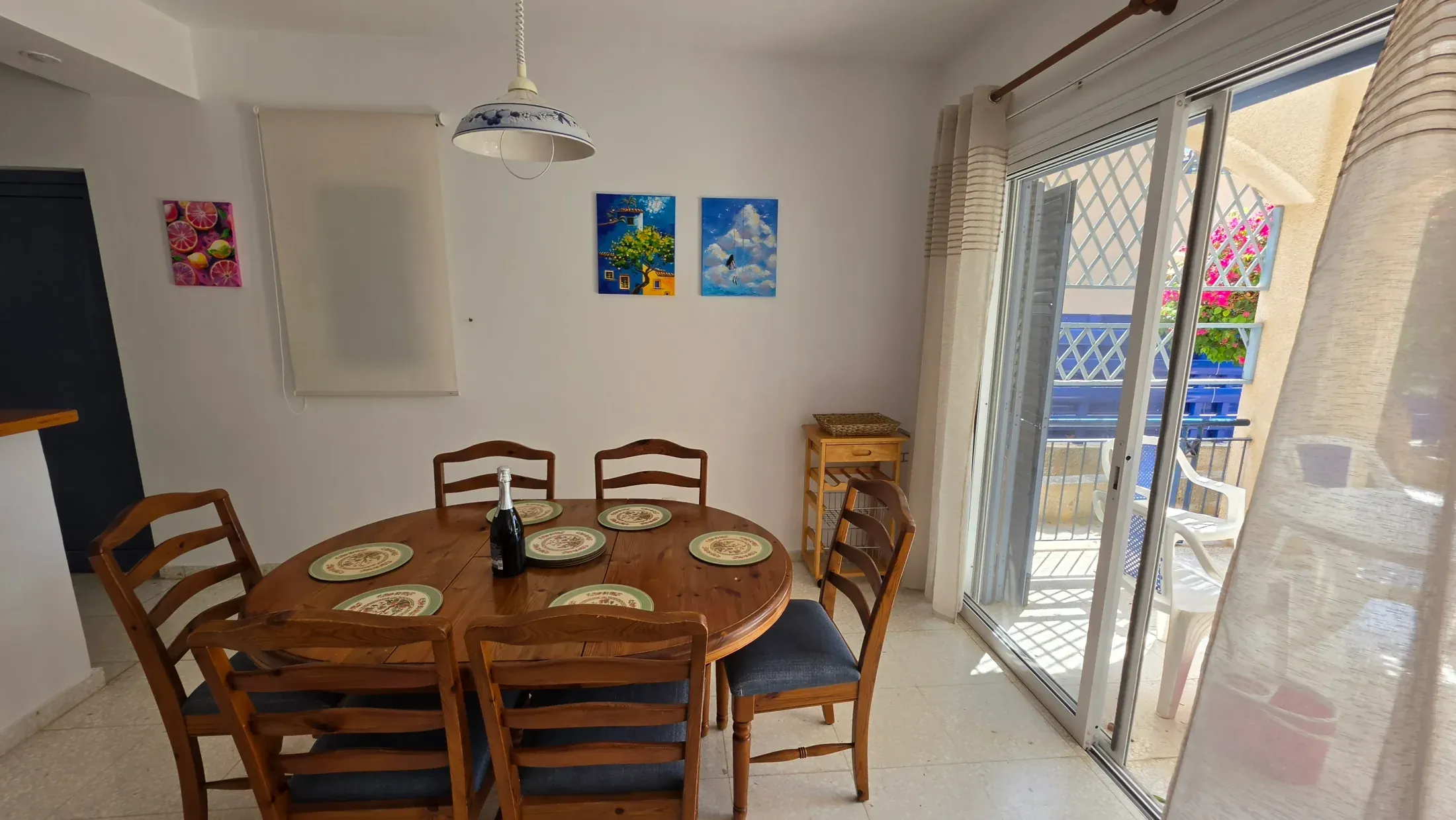 The dining table laid for six, patio doors behind