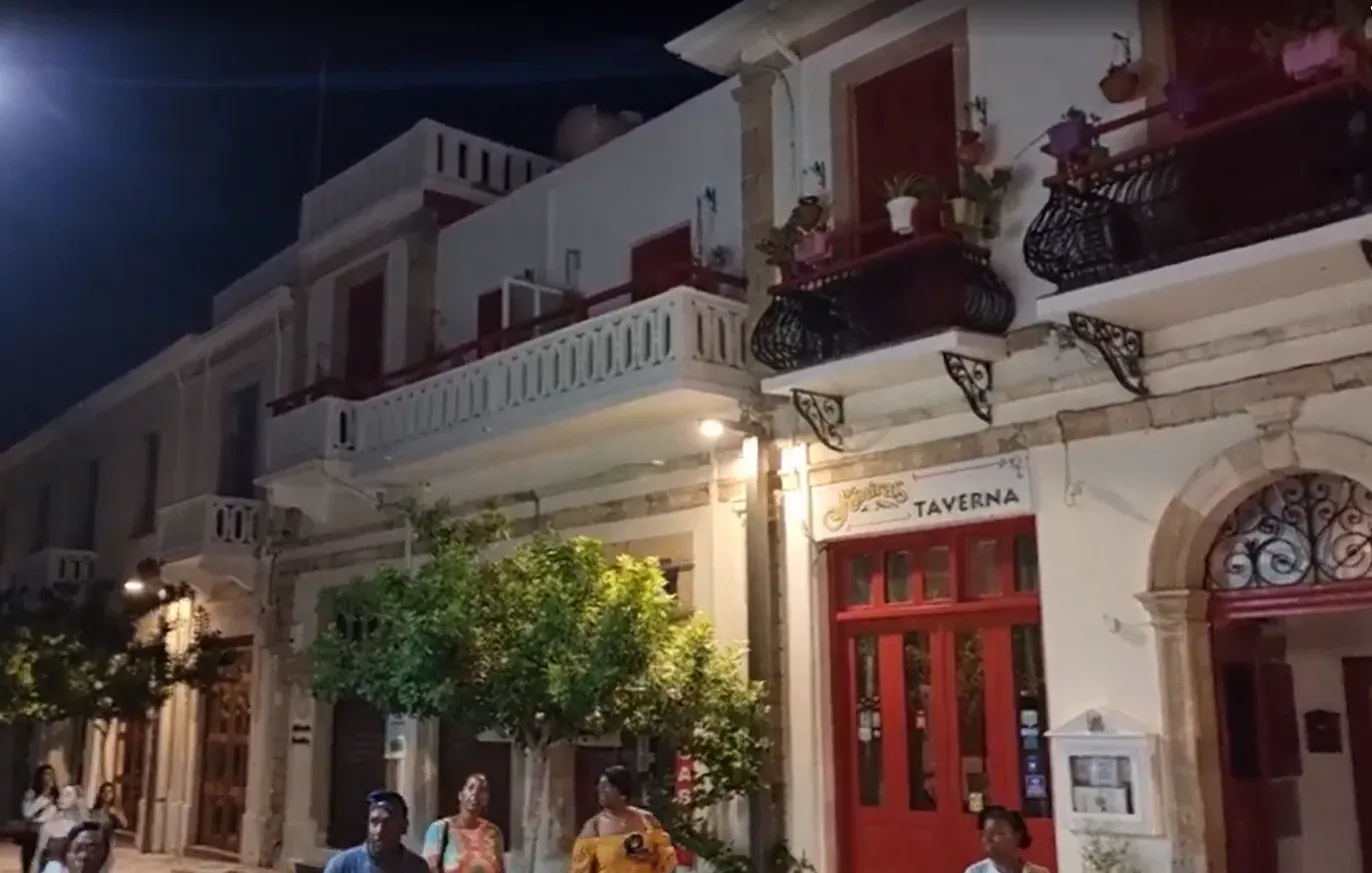 A narrow street in Paphos old town with cafés and small shops