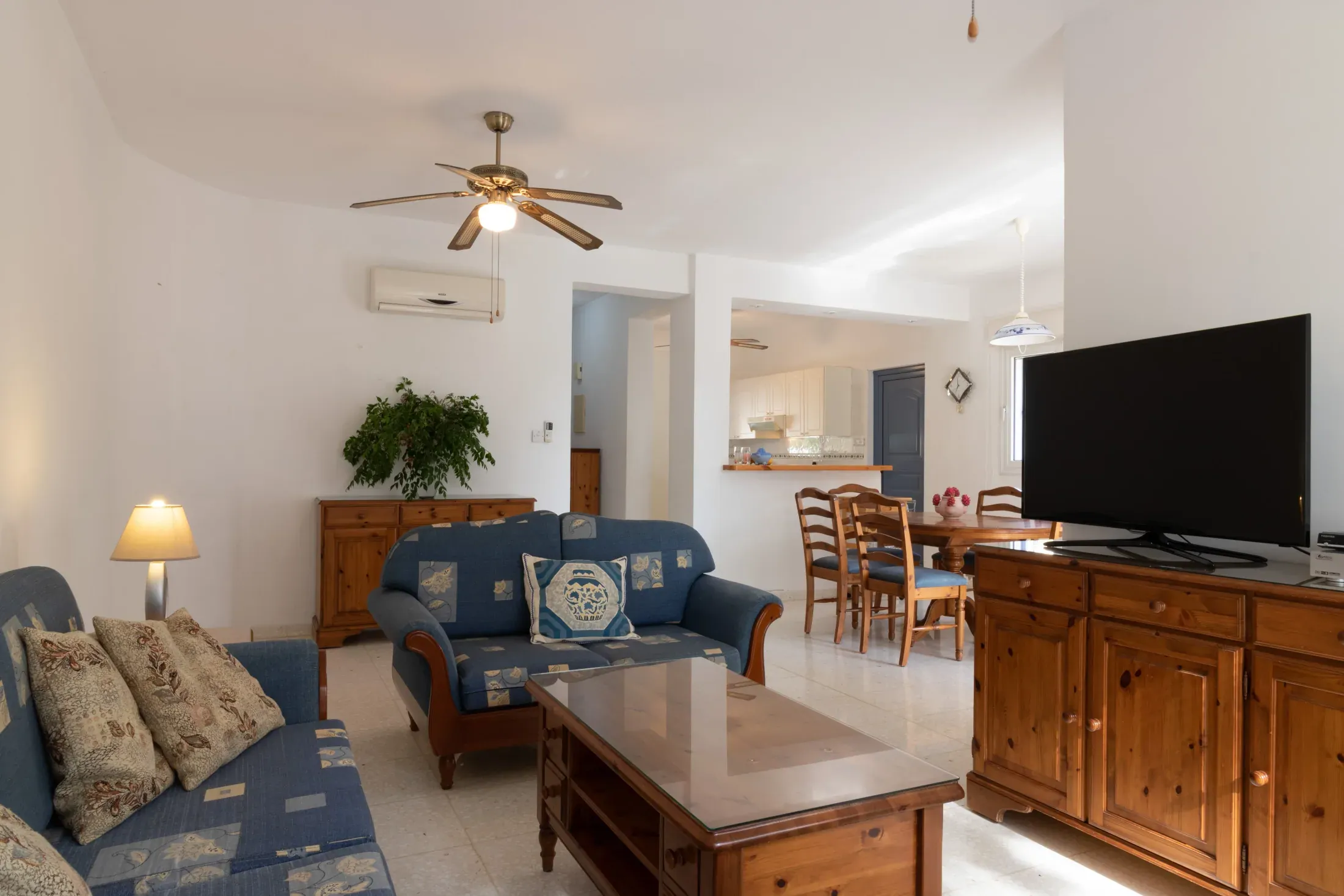 Looking from the living room towards the kitchen, paintings on the wall