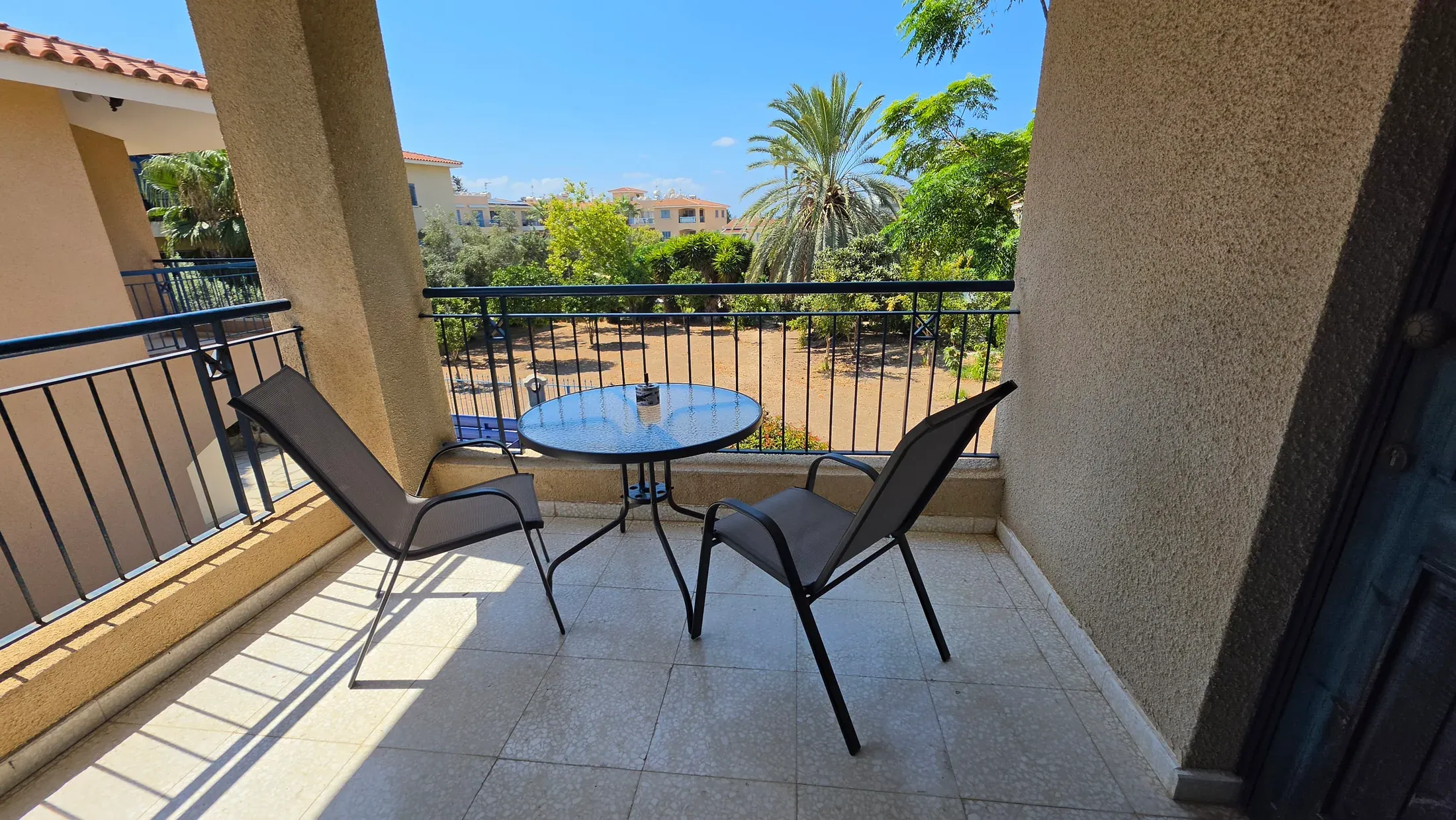 The covered patio at Villa Nadezda with new table and chairs looking out over the gardens