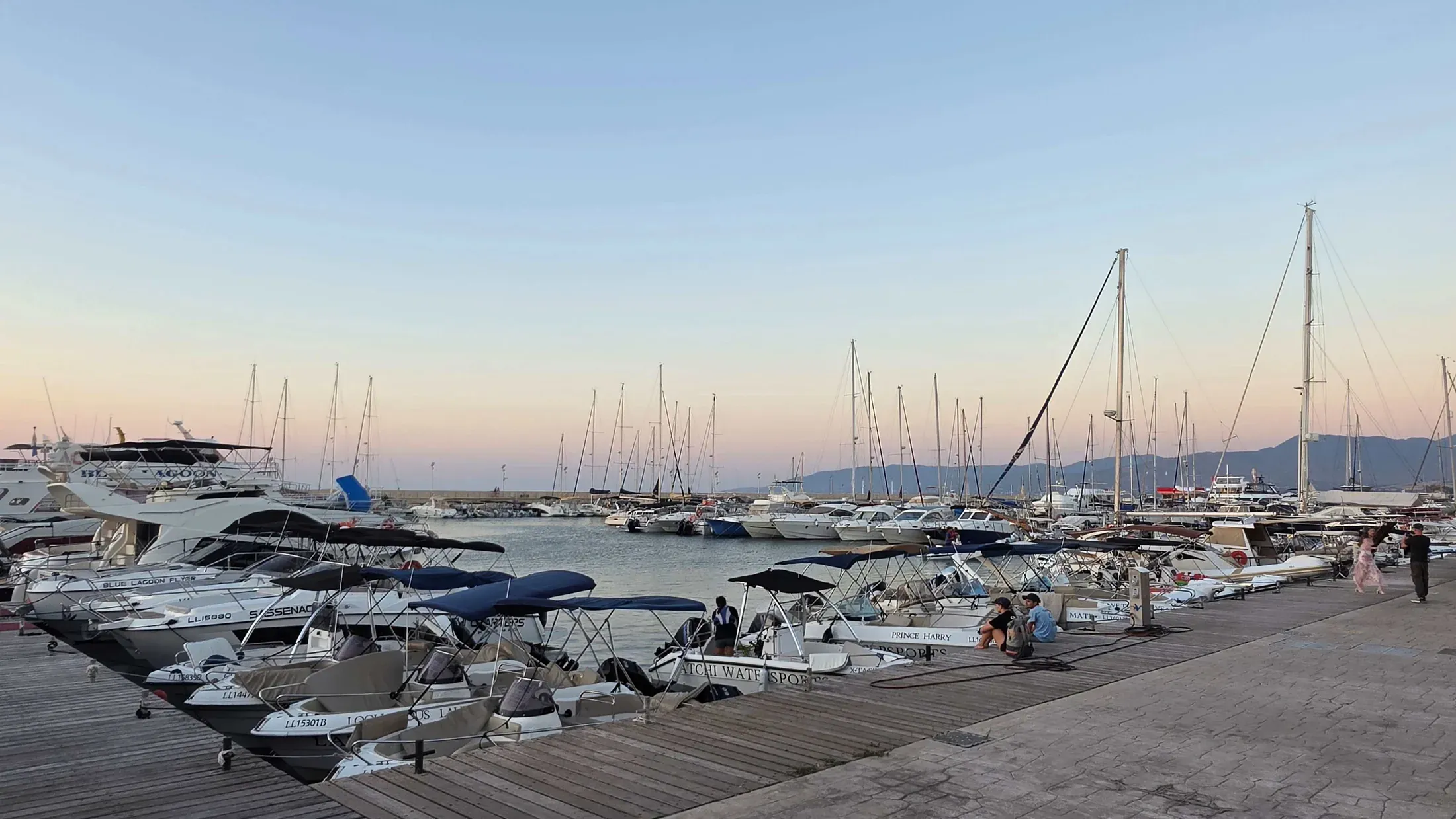 Yachts and fishing boats moored at Latchi harbour at dusk