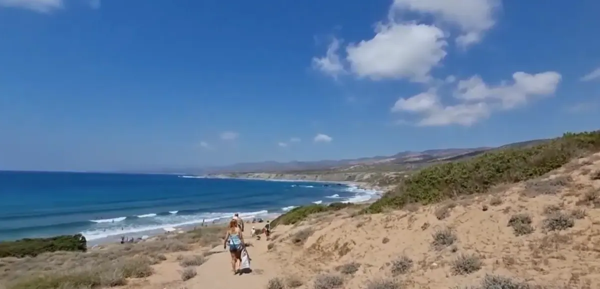 Clear shallow water and cliffs at Lara Beach, Akamas
