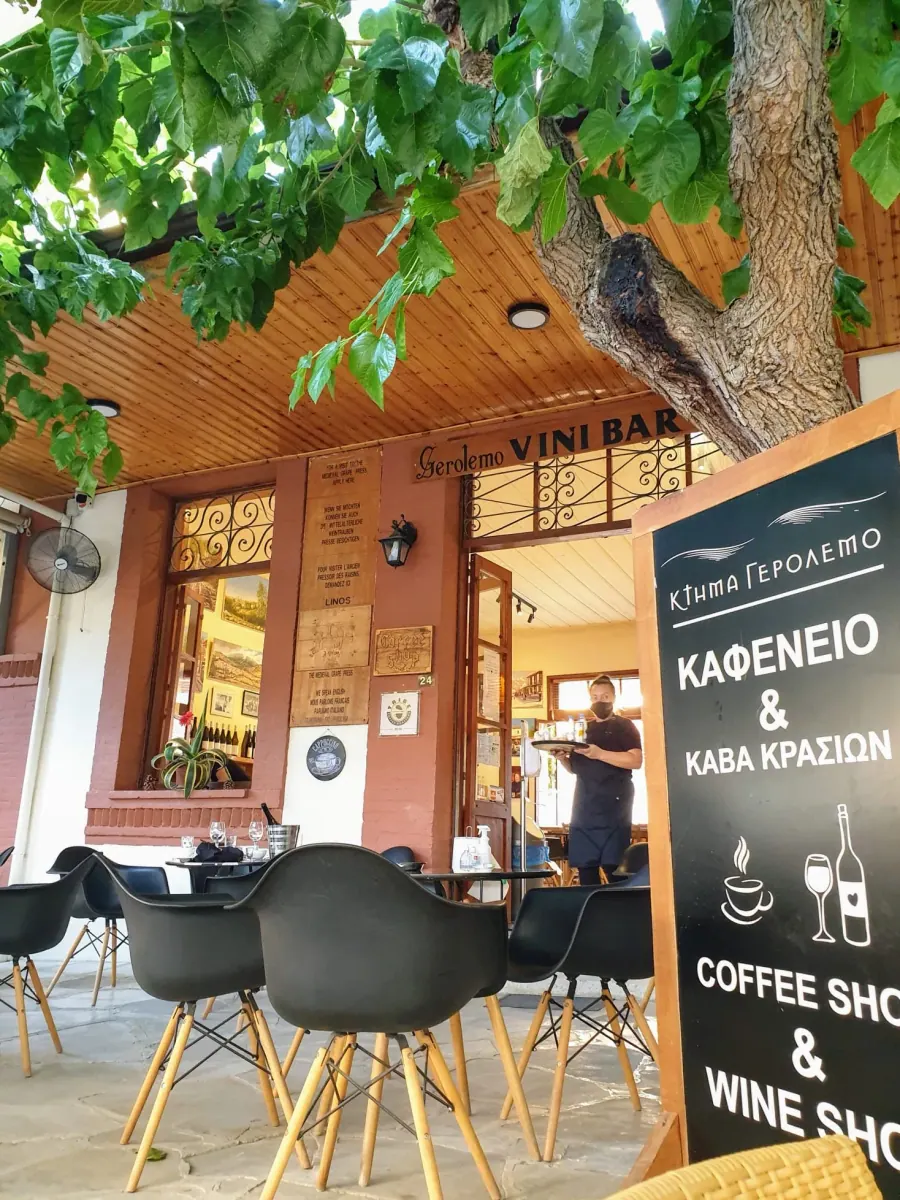 Shaded taverna terrace with wooden tables in Omodos