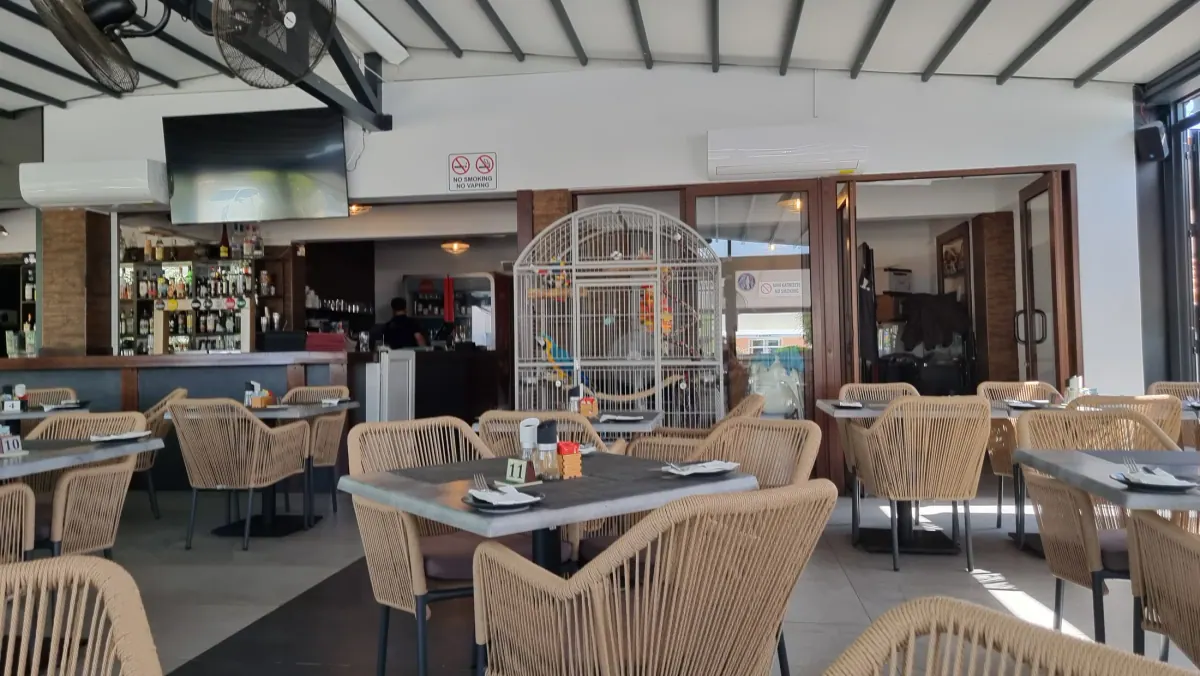 Spacious tables and large windows at the Parrot Restaurant in Paphos